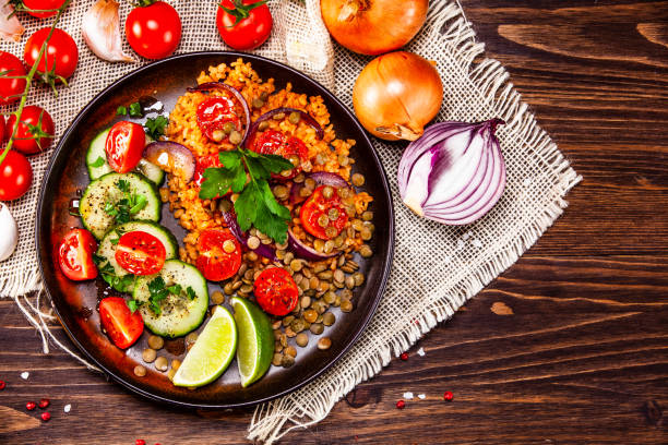 istock Groats and vegetables on wooden table 1139652648
