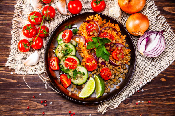 istock Groats and vegetables on wooden table 1139652768