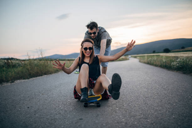 istock Cute couple having fun with skateboard together 1139654746