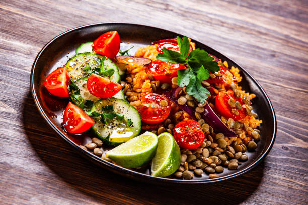 istock Groats and vegetables on wooden table 1139655459