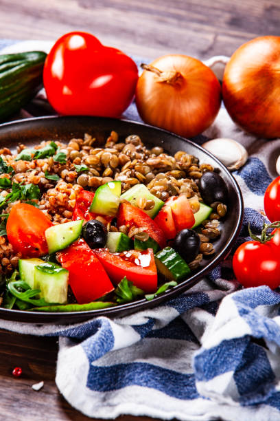 istock Groats and vegetables on wooden table 1139656874