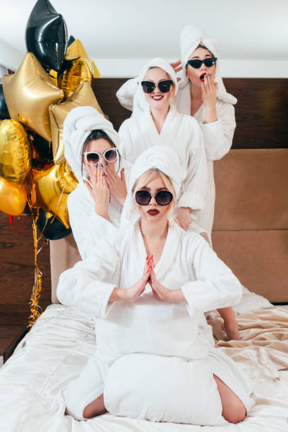 istock celebration spa party fun women posing bathrobes 1139657120