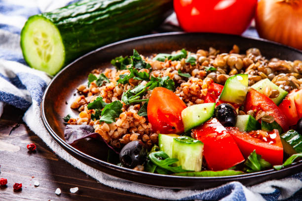 istock Groats and vegetables on wooden table 1139657147