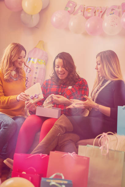 Pregnant woman celebrating baby shower party with friends. stock photo