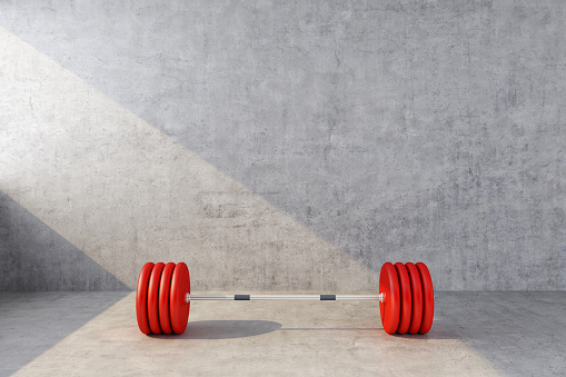 red sports barbell on the background of a concrete wall. 3d rendering
