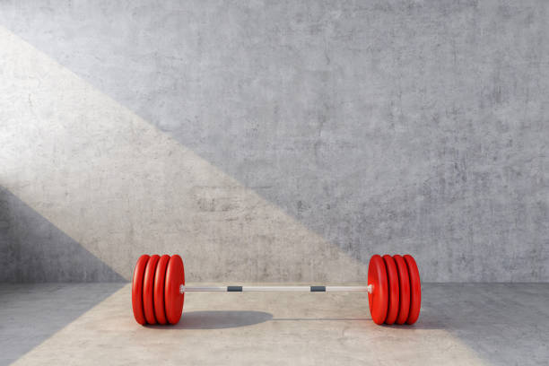 red sports barbell on the background of a concrete wall stock photo