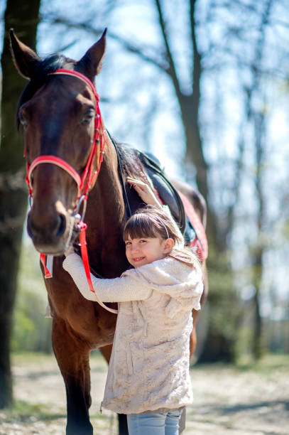 istock Young girl with horse in forest 1139659402