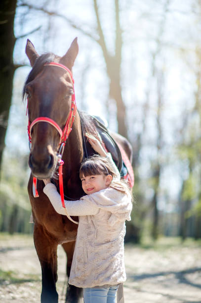 istock Young girl with horse in forest 1139659570