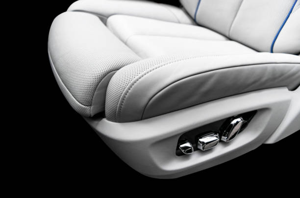 istock White leather interior of a car. Perforated white leather comfortable seats with stitching isolated on black background. Car interior details. Car detailing. Car inside 1139659765