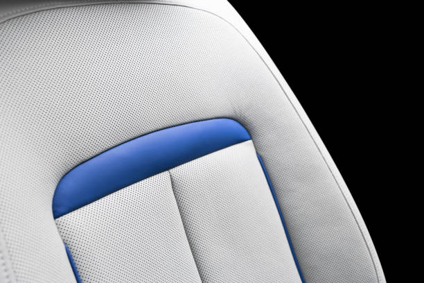 istock White leather interior of a car. Perforated white leather comfortable seats with stitching isolated on black background. Car interior details. Car detailing. Car inside 1139659878