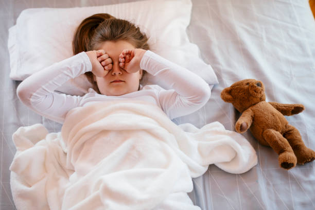 istock Beautiful girl in bed with her teddy bear 1139659895