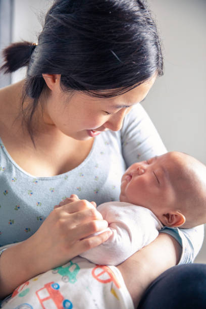 istock Mother holding her baby 1139659964