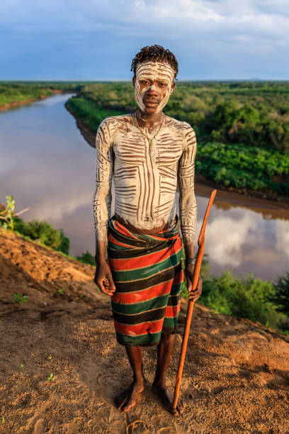 Young African man from Karo tribe, East Africa The Karo tribe is a tribe that lives in the southwestern region of the Omo Valley near Kenya, Africa. They are largely pastoralists. omo river photos stock pictures, royalty-free photos & images