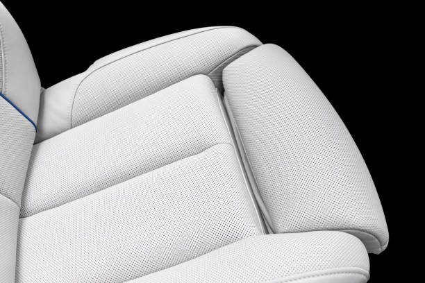 istock White leather interior of a car. Perforated white leather comfortable seats with stitching isolated on black background. Car interior details. Car detailing. Car inside 1139660022