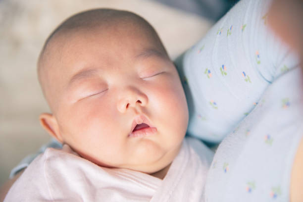 istock Mother Embracing Baby Sleeping 1139660596