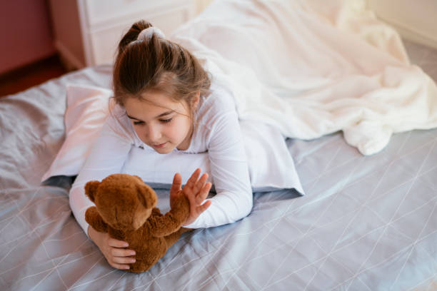 istock Beautiful girl in bed with her teddy bear 1139661592