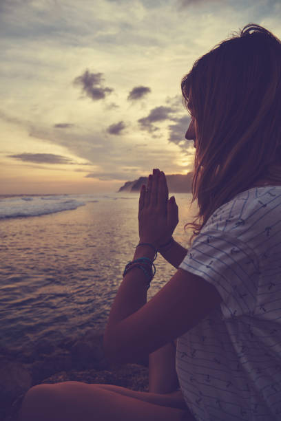 istock Young woman practicing yoga - meditation on the beach. 1139661782
