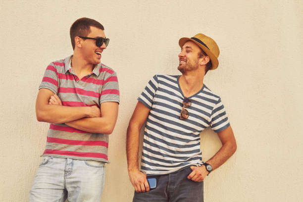 istock Male friends using cellphone outdoors. 1139661838