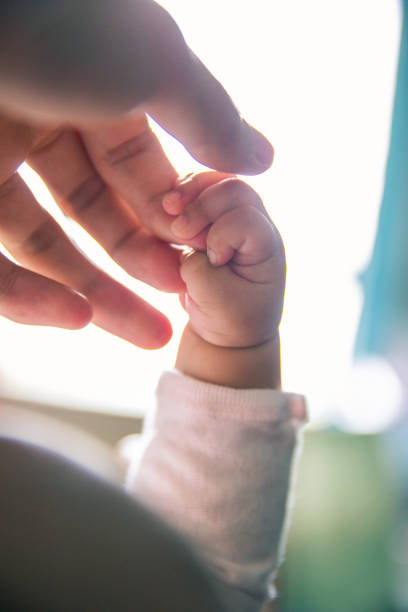 istock Baby hand holding her mother hand 1139663618