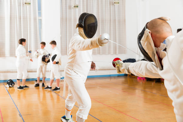 istock Adult fencer practicing lunge with foil 1139665280