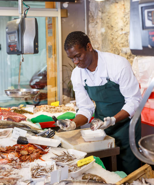 istock Salesman preparing fish for sale 1139665632
