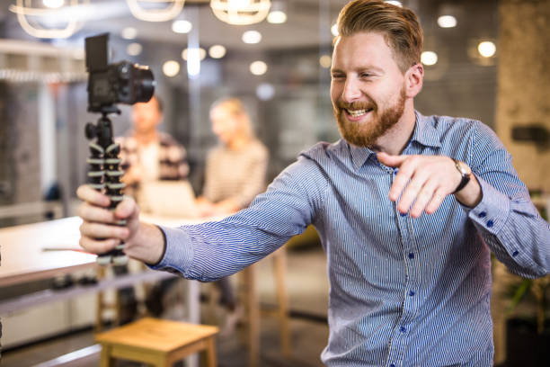 istock Young happy redhead freelancer taking a selfie with digital camera. 1139665970