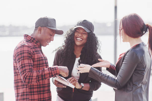 istock A group of young multinational people with a book, students studying in the open air 1139666050