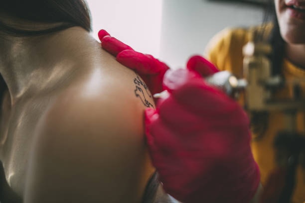 istock Tattoo artist drawing on client's skin. 1139666232