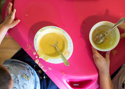 Little boy and girl  enjoying in cauliflower soup