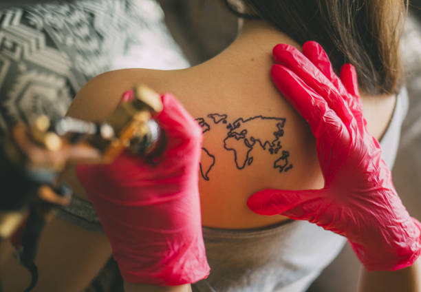 istock Tattoo artist drawing on client's skin. 1139666802