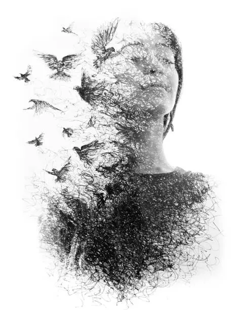 Photo of Paintography. Double Exposure portrait of an elegant woman with closed eyes combined with hand made pencil drawing of a flock of birds flying freely resembling disintegrating particles of her being, black and white