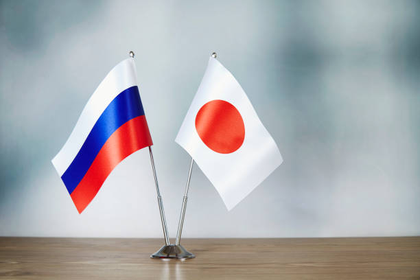 istock Russian and Japanese flag standing on the table 1139669579