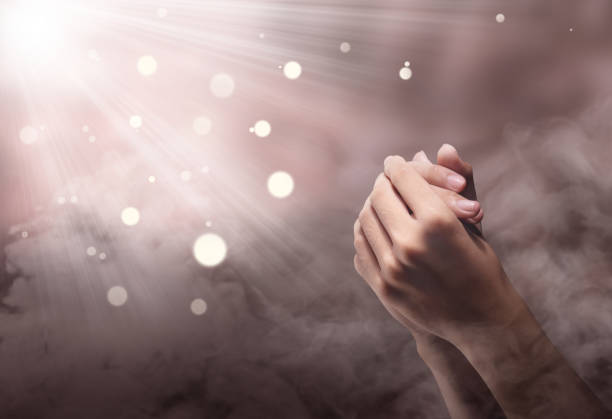 istock Male hands in praying position with ray 1139669805