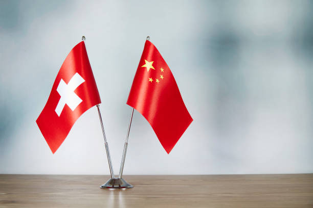 istock Chinese and Swiss flag standing on the table 1139669843
