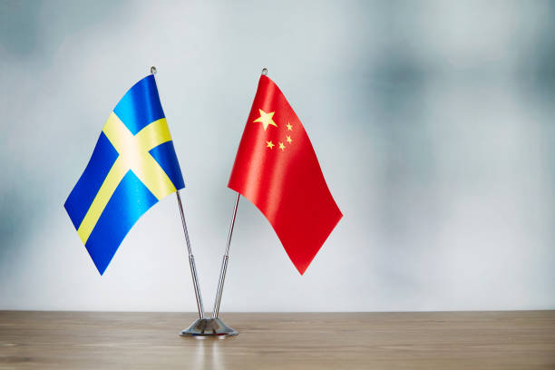 istock Chinese and Swedish flag standing on the table 1139670412