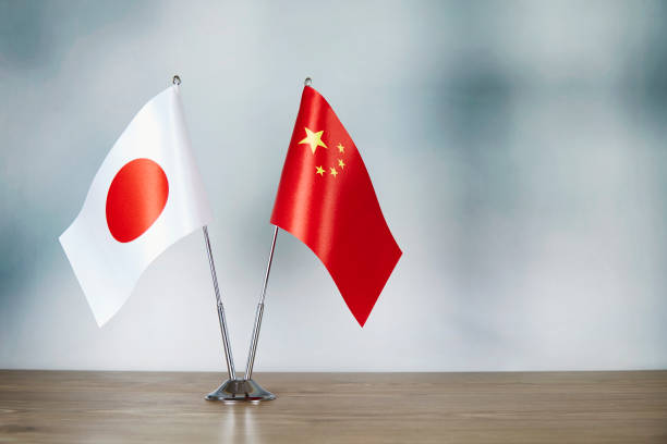 Chinese and Japanese flag standing on the table