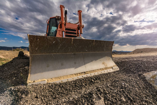 istock Excavator leveling pavement in the construction of a road 1139670832
