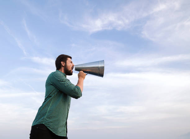 istock Man yelling trough a megaphone 1139671283