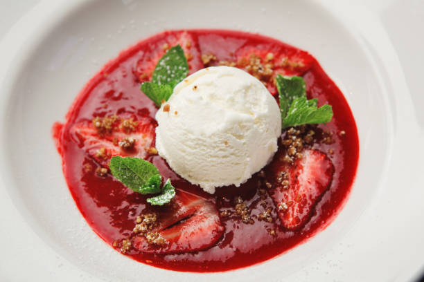 istock scoop of white ice cream with fruit in plate. Top view. 1139672561