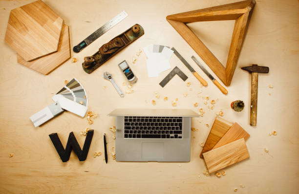 istock Carpentry work tools and laptop on background with wooden cuttings. 1139672926