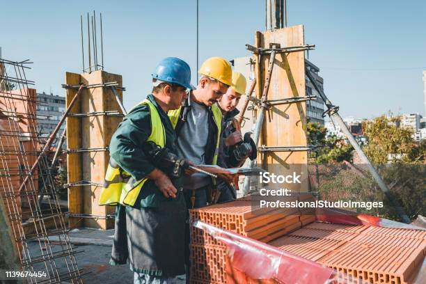 Construction Worker Understanding Experienced Construction Worker Is Explaining Building Project To His ...