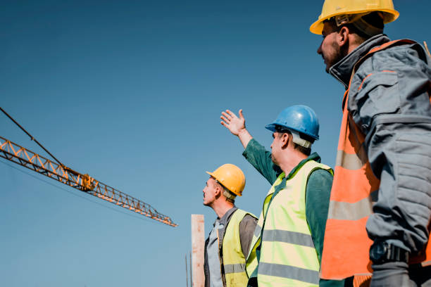 istock Construction Workers are Checking Building Site With Crane in the Background 1139674760