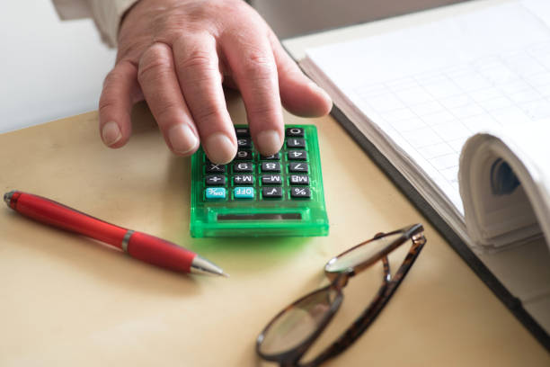 istock A Man in the Office uses a Calculator 1139679940