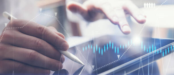 istock Businessman holding tablet on hand and using electronic pen while working at office.Concept of digital diagram,graph interfaces,virtual screen,connections icon.Wide format. 1139680951