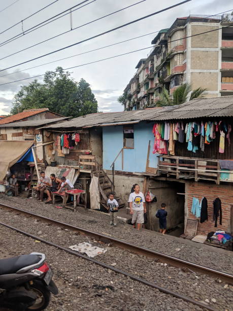 Slum area in Jakarta Jakarta, Indonesia - March 23, 2019: Slum area along railway tracks in Tanah Abang district. jakarta slums stock pictures, royalty-free photos & images