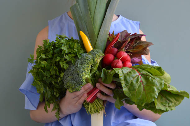istock Girl holding vegetables bouquet 1139686666