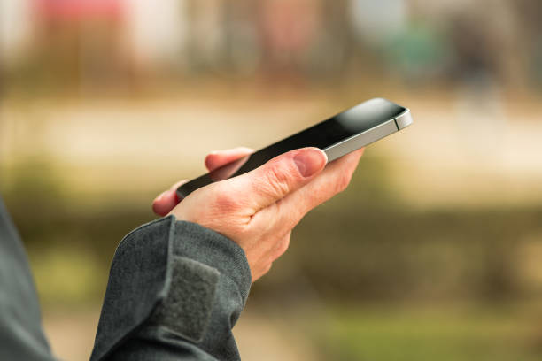 istock Woman using smartphone outdoors 1139686964