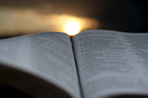 istock Open Bible with wonderful sunset in the background. 1139690003