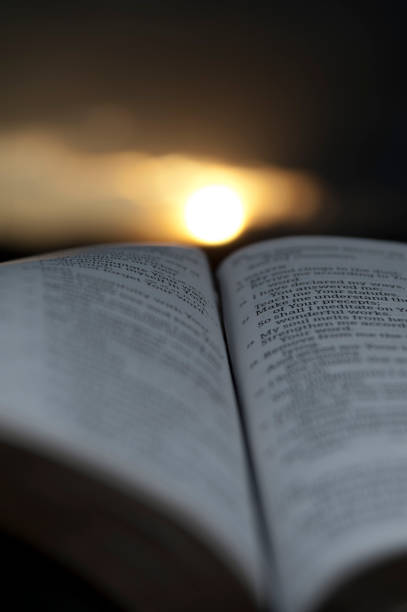 istock Open Bible with glorious sunset in the background. 1139691434