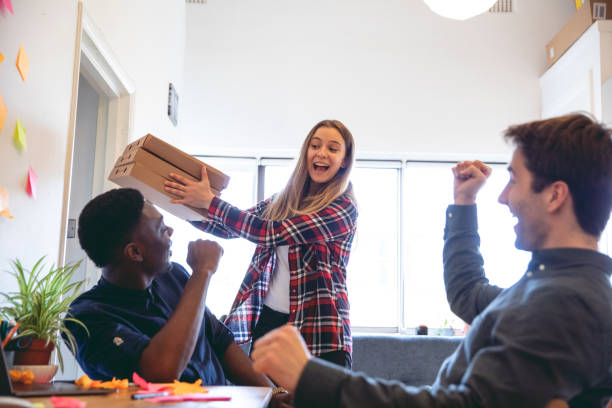 istock Lunch break in the office with a fresh made pizza 1139692659